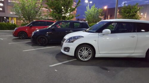 Trio of Suzuki Swift Hatchbacks Parked at Night Desktop Wallpaper