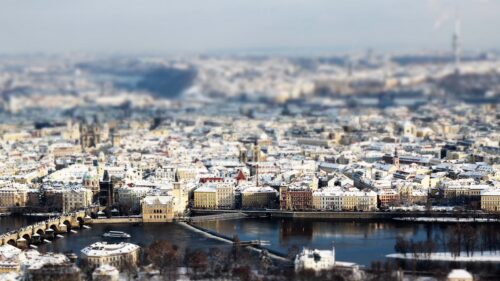 Tilt Shift View of Snowy Prague Cityscape with Vltava River 4K Wallpaper