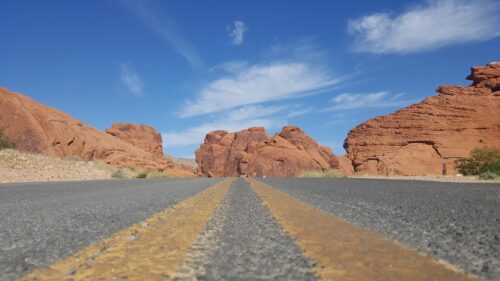 Scenic Desert Road Through Red Rock Mountains 4K Desktop Wallpaper