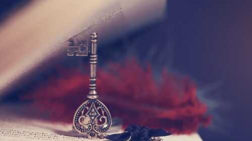 Vintage Skeleton Key and Red Feather on Old Book Aesthetic PC Wallpaper