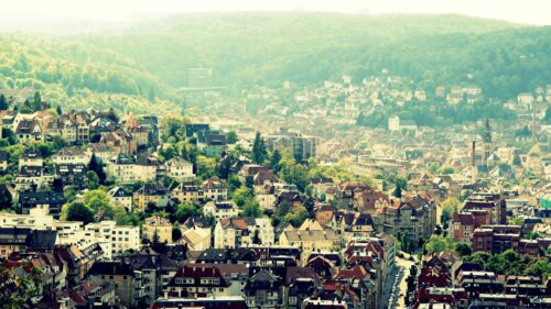 Stunning Aerial View of a European City Nestled in Green Hills PC Wallpaper