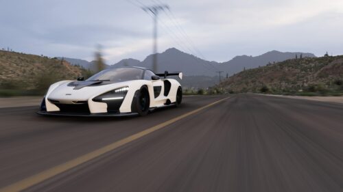 White McLaren Senna Hypercar Driving on Desert Road 4K Wallpaper