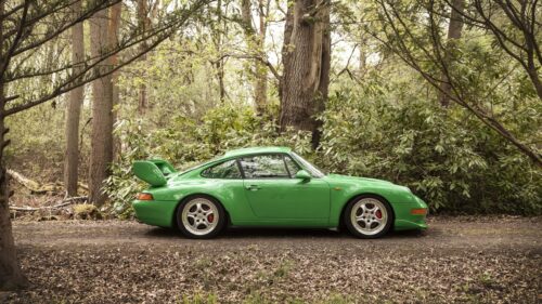 Stunning Green Porsche 911 Carrera RS Parked in an Enchanting Forest 4K Wallpaper