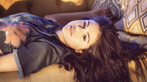 Beautiful Selena Gomez Relaxing on Sofa Portrait 4K Wallpaper