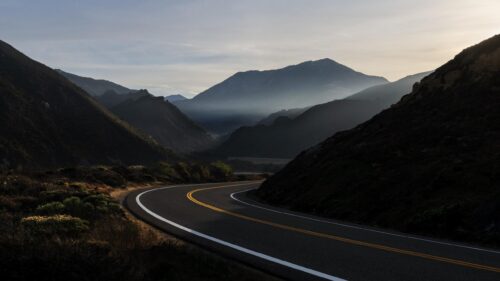 Scenic Winding Mountain Road at Sunrise PC Wallpaper