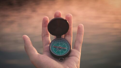 A Hand Holding a Compass at Sunset Cinematic 4K Desktop Wallpaper