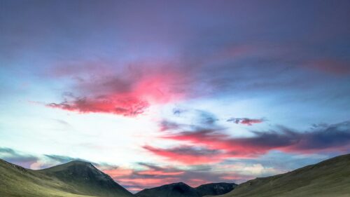 Stunning Pink Sunset Over Majestic Mountain Ranges 4K Wallpaper