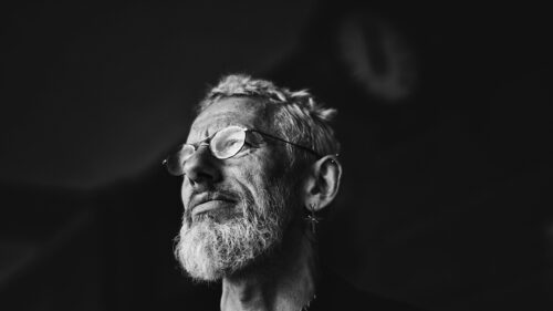 Portrait of a Reflective Bearded Man with Glasses 4K Desktop Wallpaper