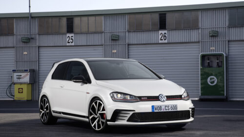 White Volkswagen Golf GTI Clubsport parked in front of industrial garages 4K Wallpaper