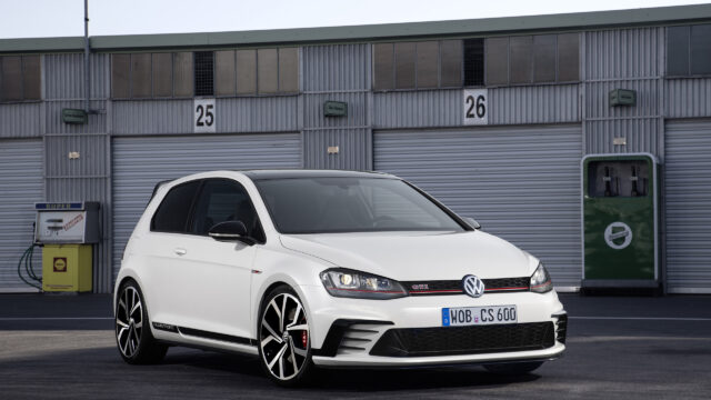 White Volkswagen Golf GTI Clubsport parked in front of industrial garages 4K Wallpaper
