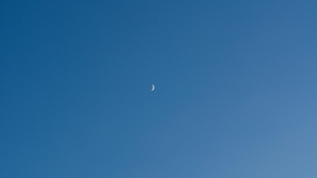 Minimalist Crescent Moon in Clear Blue Daylight Sky PC Wallpaper