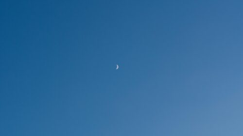 Minimalist Crescent Moon in Clear Blue Daylight Sky PC Wallpaper