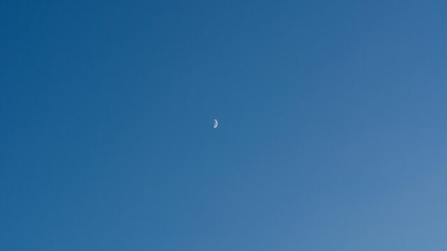 Minimalist Crescent Moon in Clear Blue Daylight Sky PC Wallpaper
