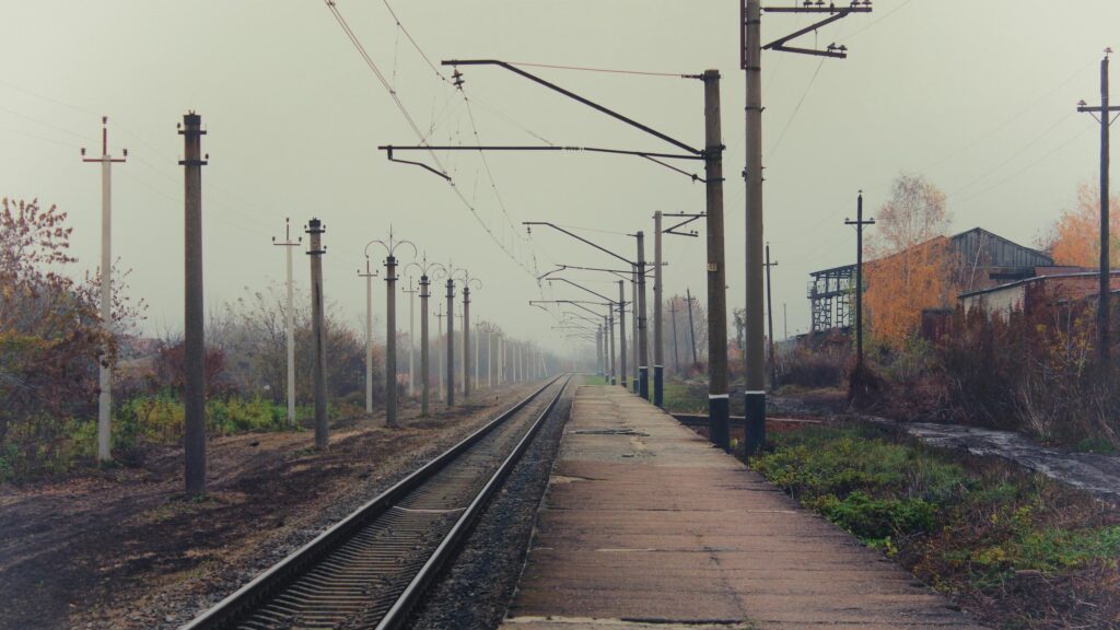 Atmospheric Misty Railway Station Track Scenery 4K Wallpaper