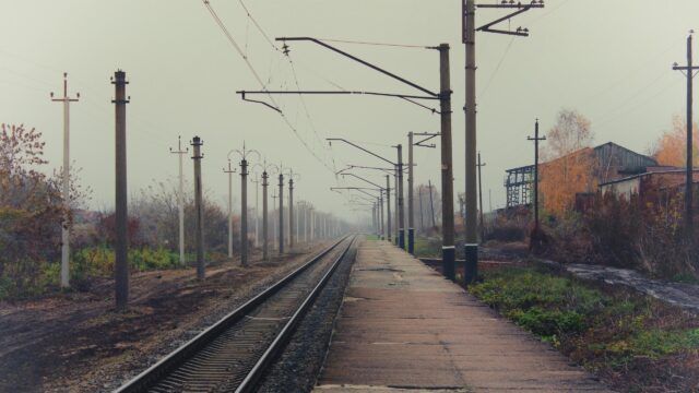 Atmospheric Misty Railway Station Track Scenery 4K Wallpaper