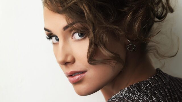 Stunning Portrait of a Beautiful Woman with Curly Brown Hair 4K Wallpaper