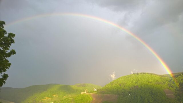 Breathtaking Rainbow Over Lush Green Mountains PC Wallpaper