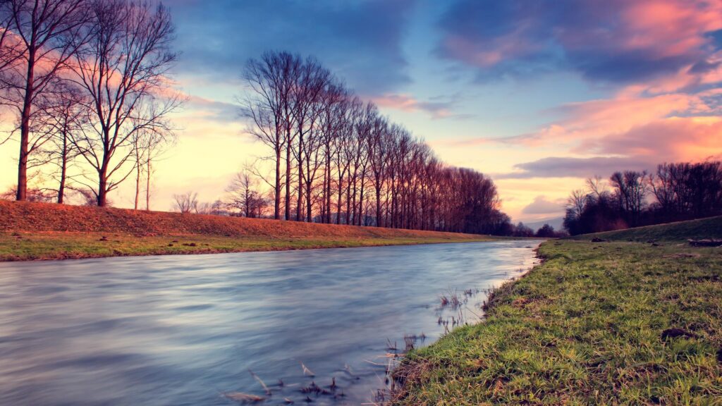 Stunning Sunset River Landscape with Bare Trees Scenic 4K Wallpaper
