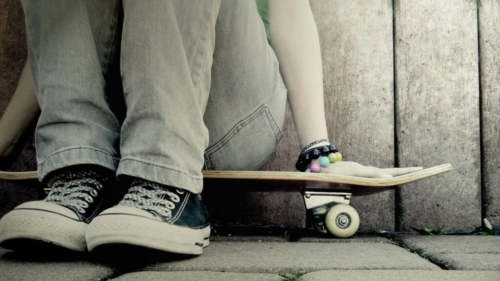 Casual Skater Sitting with Skateboard PC Wallpaper