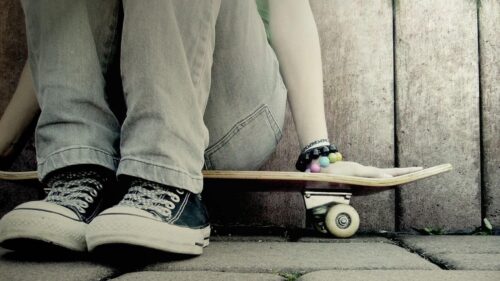 Casual Skater Sitting with Skateboard PC Wallpaper