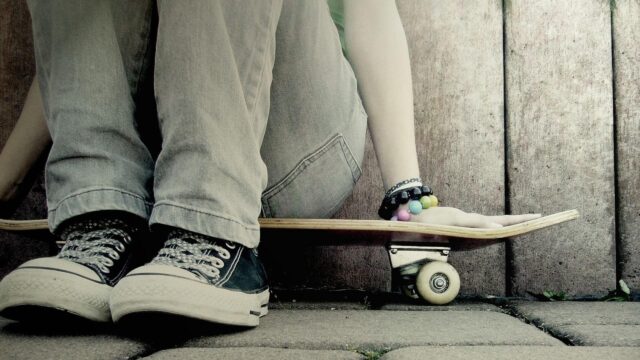 Casual Skater Sitting with Skateboard PC Wallpaper