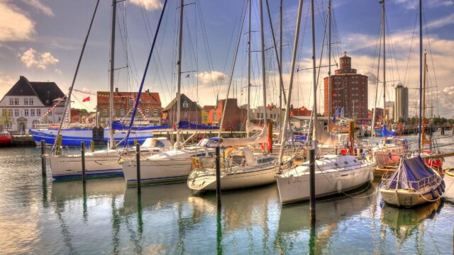Sailboats Docked in a Picturesque European Harbor Desktop Wallpaper