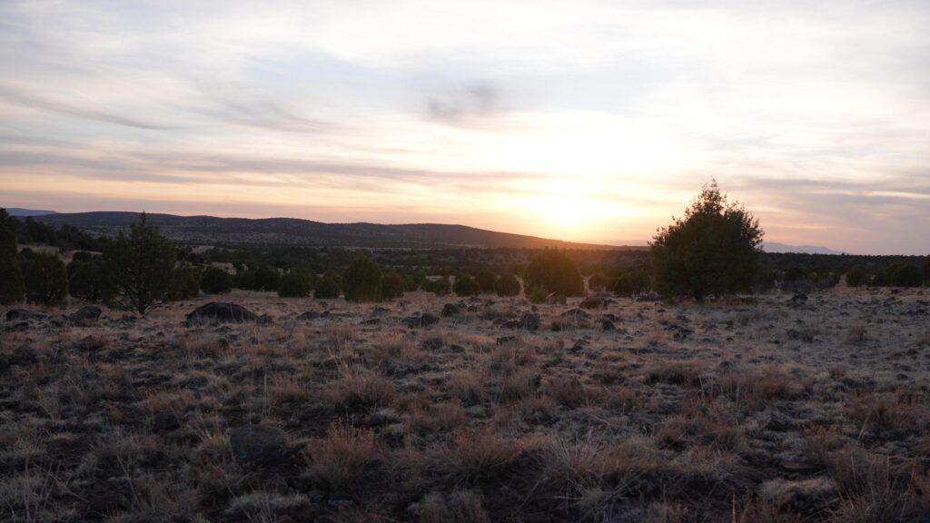 Serene Desert Sunset Over Rocky Landscape Desktop Wallpaper