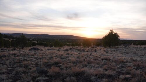 Serene Desert Sunset Over Rocky Landscape Desktop Wallpaper