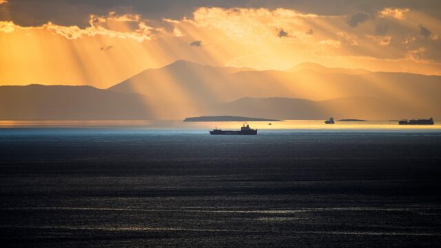 Stunning Golden Sunset Over Ocean With Cargo Ships 4K Wallpaper