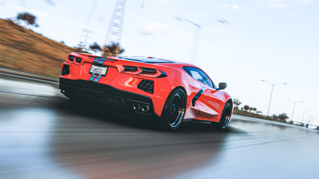 Red Chevrolet Corvette C8 Driving at High Speed Desktop Wallpaper