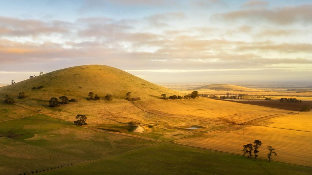 Golden Hour Over Rolling Hills and Farmland Desktop Wallpaper