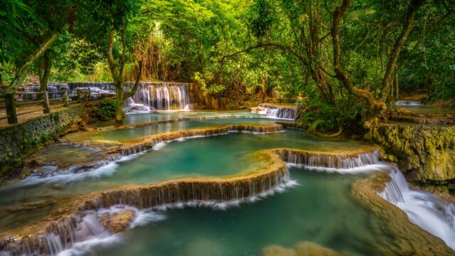 Stunning Tropical Tiered Waterfall in Lush Green Forest 4K Wallpaper