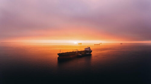 Golden Hour Cargo Ship on Calm Ocean Waters PC Wallpaper