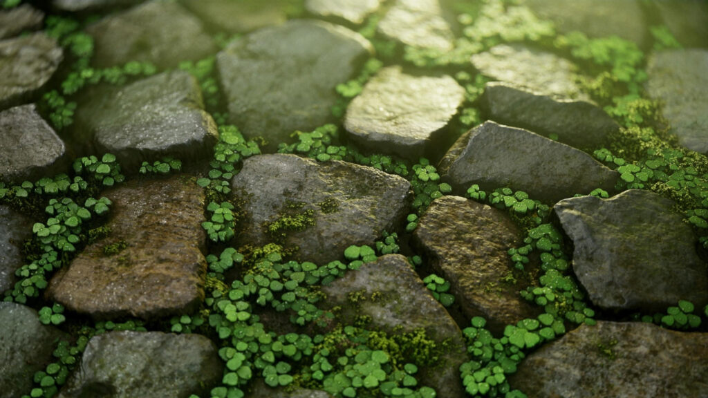 Sunlit Cobblestone Path with Lush Green Plants Desktop Wallpaper