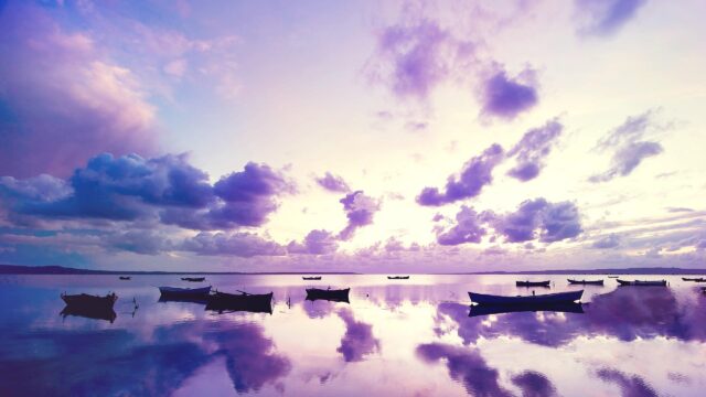 Serene Purple Sunset Over Calm Lake With Wooden Boats PC Wallpaper