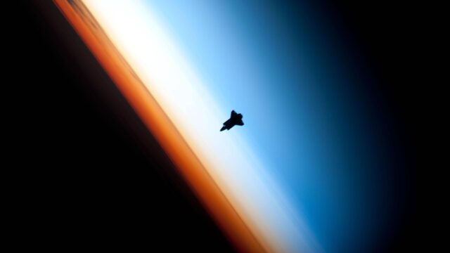 Space Shuttle Silhouette Against Earth Horizon Atmospheric Glow 4K Wallpaper