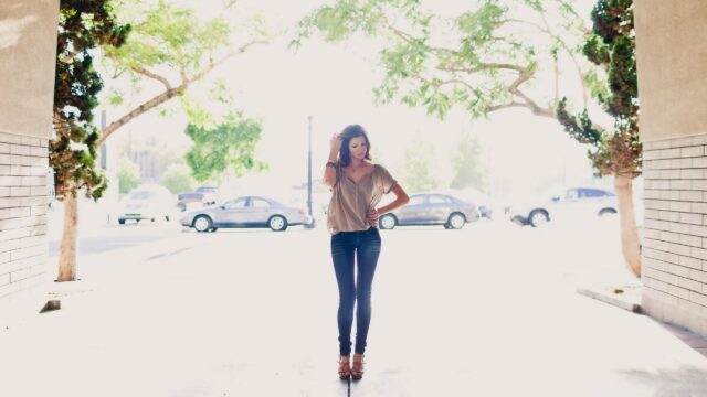 Stunning Woman Standing in Urban Sunlight 4K PC Wallpaper