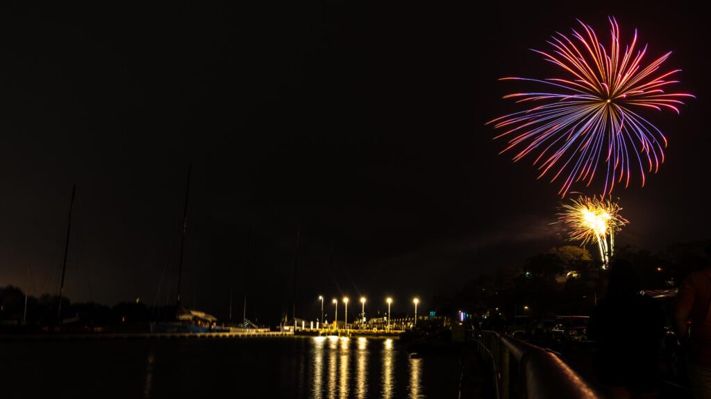 Stunning Night Fireworks Over Harbor Reflection 4K Wallpaper
