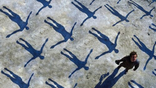Surreal Artistic Man Standing Among Human Shadows Concept 4K Wallpaper