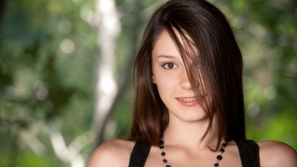 Beautiful Young Woman with Brown Hair in Nature Setting Desktop Wallpaper