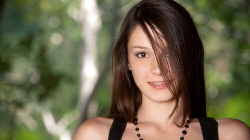 Beautiful Young Woman with Brown Hair in Nature Setting Desktop Wallpaper
