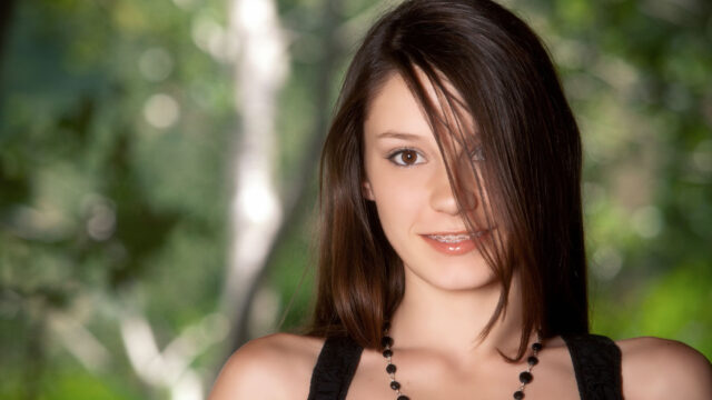 Beautiful Young Woman with Brown Hair in Nature Setting Desktop Wallpaper