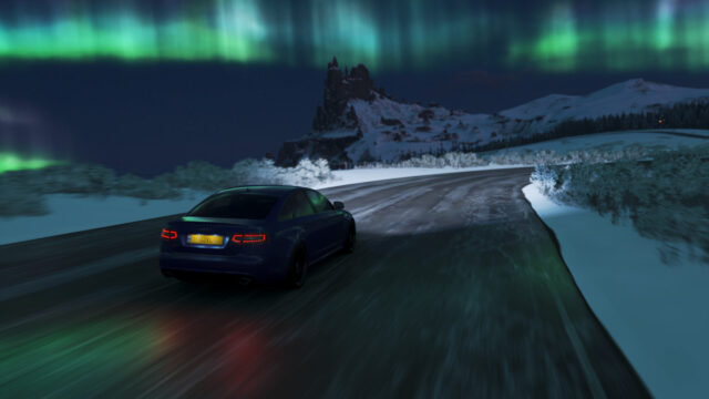 Dark Blue Audi Sedan Driving Through Snowy Night Desktop Wallpaper