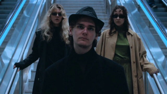 Fashionable Trio on Escalator 4K Desktop Wallpaper