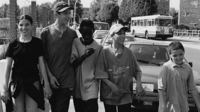 Black and White Youth Group Walking Down City Street Desktop Wallpaper