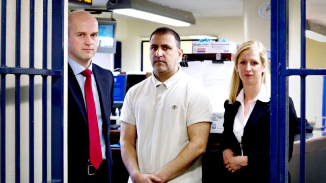 Professional Trio Standing in an Office Desktop Wallpaper
