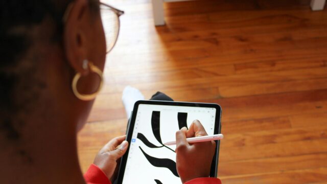 Graphic Designer Creating Digital Art on Tablet Desktop Wallpaper