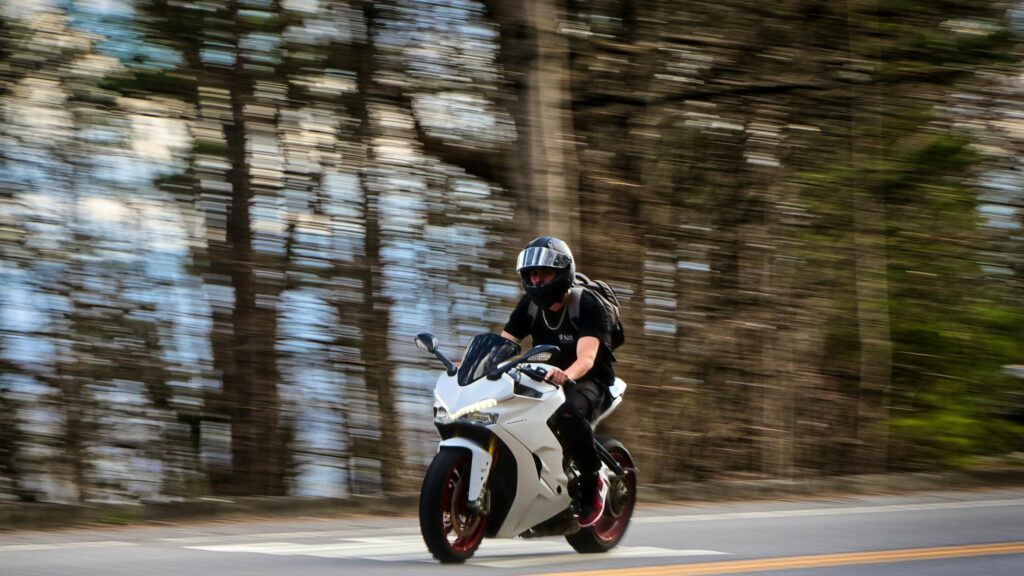 Speeding Ducati Superbike on Forest Road 4K Desktop Wallpaper