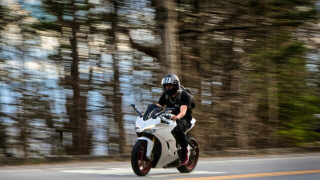 Speeding Ducati Superbike on Forest Road 4K Desktop Wallpaper