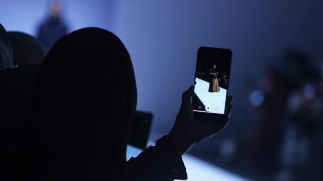 Fashion Runway Perspective Through Phone Screen 4K Wallpaper